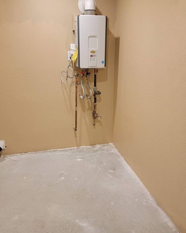 Same water heater closet with new drywall, matched texture and fresh paint